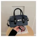Stylish denim bowling shoulder bag with black leather handle and metal lock detail for women. - Dark Blue With Black