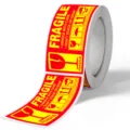 Fragile warning sticker roll detail, red and yellow self-adhesive delivery safety label. - Style 001 / 2.5x4.5cm (250 Stickers/Roll)