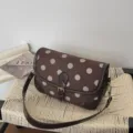Stijlvolle vintage bruine stippen schoudertas met leren afwerking en retro design. - Bruin