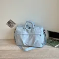 Light blue travel duffel bag with star and moon print, spacious shoulder bag for women. - Blue