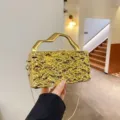 Borsa da sera strutturata in metallo dorato con manico geometrico e tracolla a catena. - Stile 1 / Oro