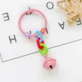 Creative bell keychain detail shot with colorful letter beads and metal ring for DIY bag decor. - Pink