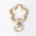 Close up detail of flower shaped metal spring snap hook keychain with colorful drip oil paint. - Light Coffee