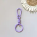 Detail view of purple zinc alloy spring keychain ring with flexible buckle and smooth finish. - Purple Hanging Clasp