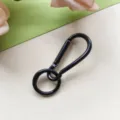 Close-up detail of black metal spring ring and snap hook, ideal for DIY craft charms. - Black Gourd Clasp + Spring Ring