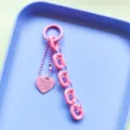 Detailed view of handmade pink jelly acrylic heart keychain and bag pendant, close-up shot. - Pink Heart Chain
