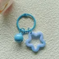 Detail van de blauwe acryl holle ster bel sleutelhanger hanger accessoire tas bedel. - Blauw