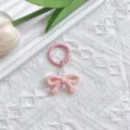Roze UV-gegalvaniseerde strik sleutelhanger, schattige tasbedel en telefoonketting accessoire. - Roze strik met veergesp