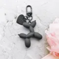 Black balloon dog keychain detail view, cute resin bag pendant and charm accessory. - Matte Black Balloon Dog with Black Carabiner