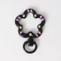 Closeup detail of the black flower shaped drip oil spring snap hook keychain diy accessory. - Black