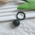 Close-up detail shot of the black metal bell pendant showing smooth shiny painted surface. - Black Spring Clasp & 22mm Bell