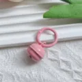 Detail shot of pink metal candy-colored bell pendant with spring buckle, ideal for DIY bag charms. - Pink Spring Clasp & 22mm Bell