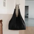 Black genuine leather hobo shoulder bag, large capacity minimalist tote for urban commuting. - Black