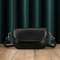 Black leather crossbody bag for women, minimalist shoulder bag with flap and metal hardware. - Black