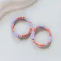 Metal donut spring ring detail showing purple enamel finish with orange and white dots. - Purple Donut Spring Clasp