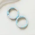 Close-up detail of blue enamel spring rings, cute polka dot design for DIY keychain crafts. - Blue Donut Spring Clasp