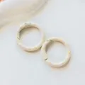 Close-up detail of metal donut spring rings, colorful oil drop cute DIY jewelry accessories. - Beige Donut Spring Clasp