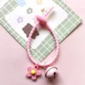 Pink silicone cable tie strap with cute flower pendant and bell DIY accessory detail view - Cable Tie Bell Flower / Pink