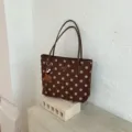 Brown polka dot tote bag detail view, showing elegant design and quality leather shoulder straps. - Brown