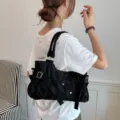 Black suede underarm shoulder bag for women, retro tote bag with metal buckles and rivets. - Black