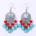 Close-up detail of vintage bohemian turquoise and red bead tassel drop earrings in silver. - Red and Blue