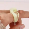 Detailed close-up shot of a chic geometric acrylic resin ring worn on a finger elegantly. - Size 7 / Yellow