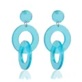 Close-up detail of bright blue acrylic geometric drop earrings with modern double circle design. - Blue