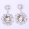 Silver starburst dangle earrings with faux pearls, showcasing intricate metal ray details. - White K/Silver