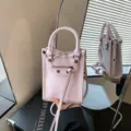 Pink leather mini vertical tote bag with metal studs and top handle for women daily wear. - Pink