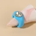Closeup of the blue acrylic chunky ring with a sparkly heart rhinestone detail on cone prop. - One Size / Blue
