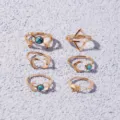 Gold metal ring set of 6 featuring turquoise stones, geometric triangles, and vintage moon designs. - One Size / Gold