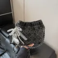 Black quilted bucket bag with chain strap, pearl string and bow pendant for women. - With Pendant / Black