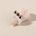 Close-up detail shot of a punk style acrylic ring featuring striking gold cone spike studs. - One Size / White