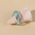 Detailed shot of a minimalist translucent light blue acrylic ring on a marbled cone display stand. - One Size / Light Blue / Green