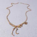 Gold dinosaur skeleton pendant necklace with fine chain for women fashion jewelry detail view. - Gold