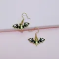 Close-up detail of the punk style black and white enamel bat earrings with gold-toned hooks. - Bat Hook Earrings Only (Without Necklace)