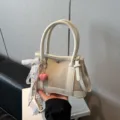 Detail view of stylish casual women canvas shoulder bag, beige tote with cute heart charm. - With Charm Style / White with Pendant