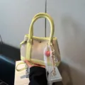 Stylish canvas shoulder bag with yellow leather trim, cute heart pendant and lace ribbon. - With Charm Style / Yellow with Pendant