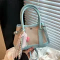 Casual light blue canvas bucket bag with shoulder strap, lace ribbon, and heart pendant. - With Charm Style / Blue with Charm