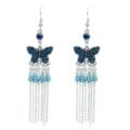 Elegante blauwe kristalen vlinder oorbellen met lange zilveren metalen kwastjes. - Antiek Zilver-Meerblauw