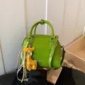Green leather shoulder crossbody bag with cute yellow giraffe pendant for women commuting daily. - Green With Pendant