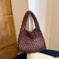 Detailed shot of brown woven mesh shoulder bag, minimalist macrame texture and style. - Coffee