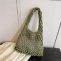 Green woven shoulder bag detail, stylish mesh design, chic underarm purse close up. - Dark Green