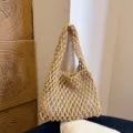 Detailed shot of the stylish woven knit shoulder underarm bag showcasing exquisite texture. - Khaki