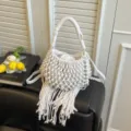 White woven hollow bucket bag with chic fringe handles, perfect summer resort crossbody. - Off White