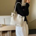 Woven shoulder bag for women, stylish cream white leather tote handbag for daily commuting. - White