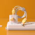 Cute silicone data cable protector set with candy shape and cartoon charger decoration. - Orange and Yellow (2-Pack)