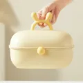 Bonita caja de joyas infantil con orejas de conejo organizador de accesorios amarillo. - Amarillo