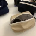 Canvas cosmetic bag detail showing large capacity, durable zipper, and neat interior storage. - Khaki