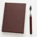 Brown A6 hardcover notebook with pink inner pages and palette knife prop, minimalist diary. - 1 Pack / Brown